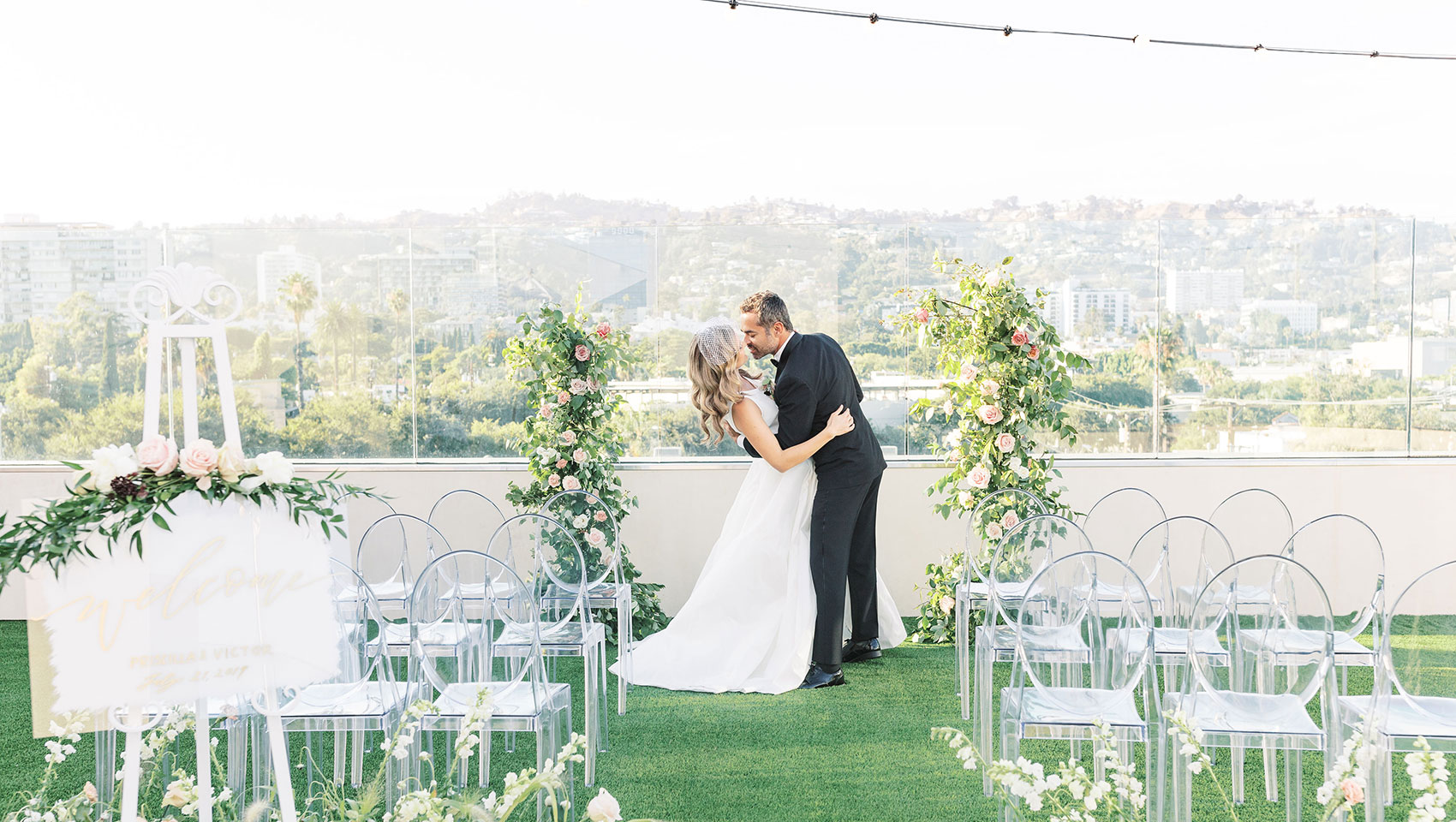 couple kiss during rooftop wedding at La Peer