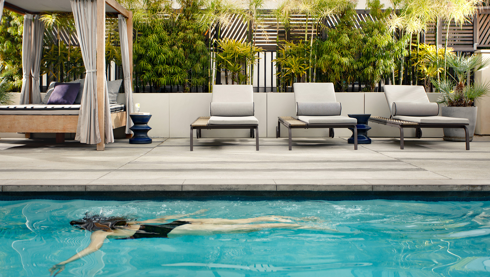 woman swimming in Kimpton La Peer Hotel Pool
