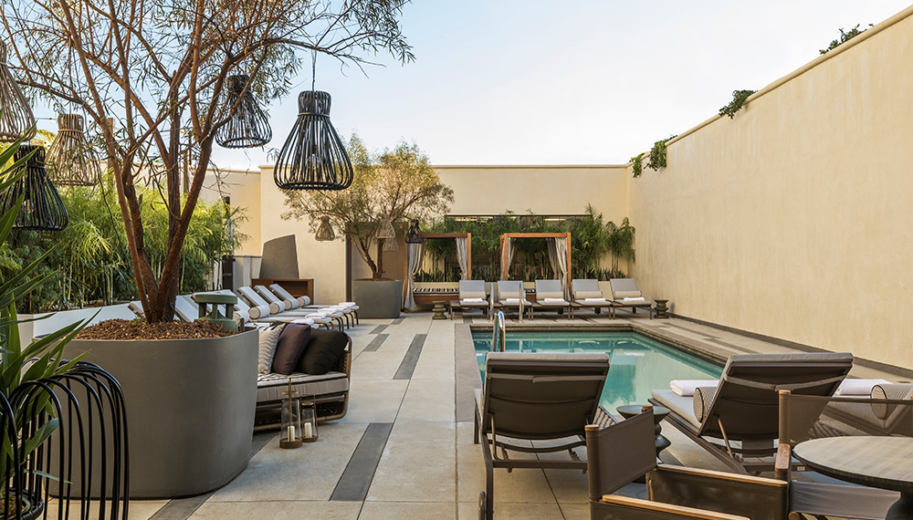 View of Kimpton La Peer pool with cabanas at the far end