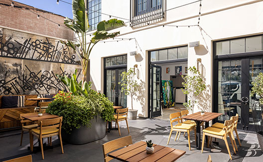 Tables in the Retna Courtyard at Kimpton La Peer Hotel